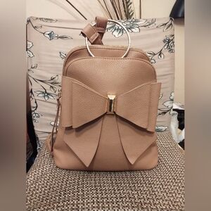 Crossi women's tan bow mini back pack w/ adjustable straps and interior pockets
